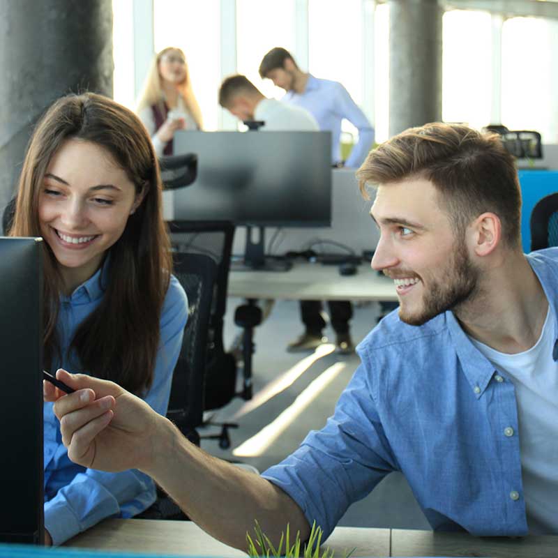 Two people collaborating on book writing, with a speech bubble icon containing text indicating writing services.