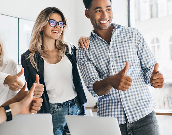 A happy group giving thumbs up, possibly after reviewing book proofreading services.